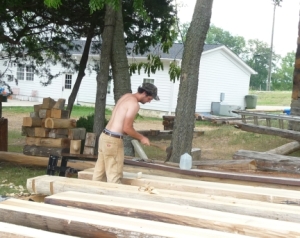 Log home specialist hand-shapes logs